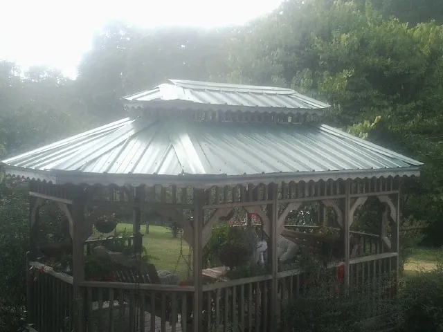 Two tier green metal roof on a garden gazebo in Mcdonough